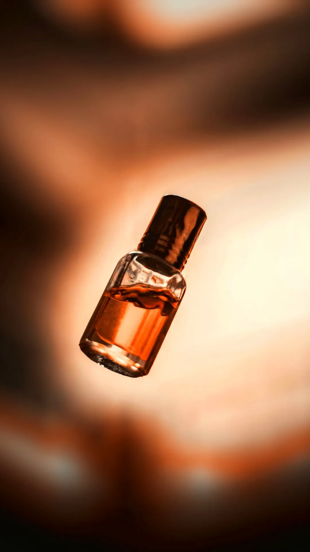 Single amber vial in a warm glow