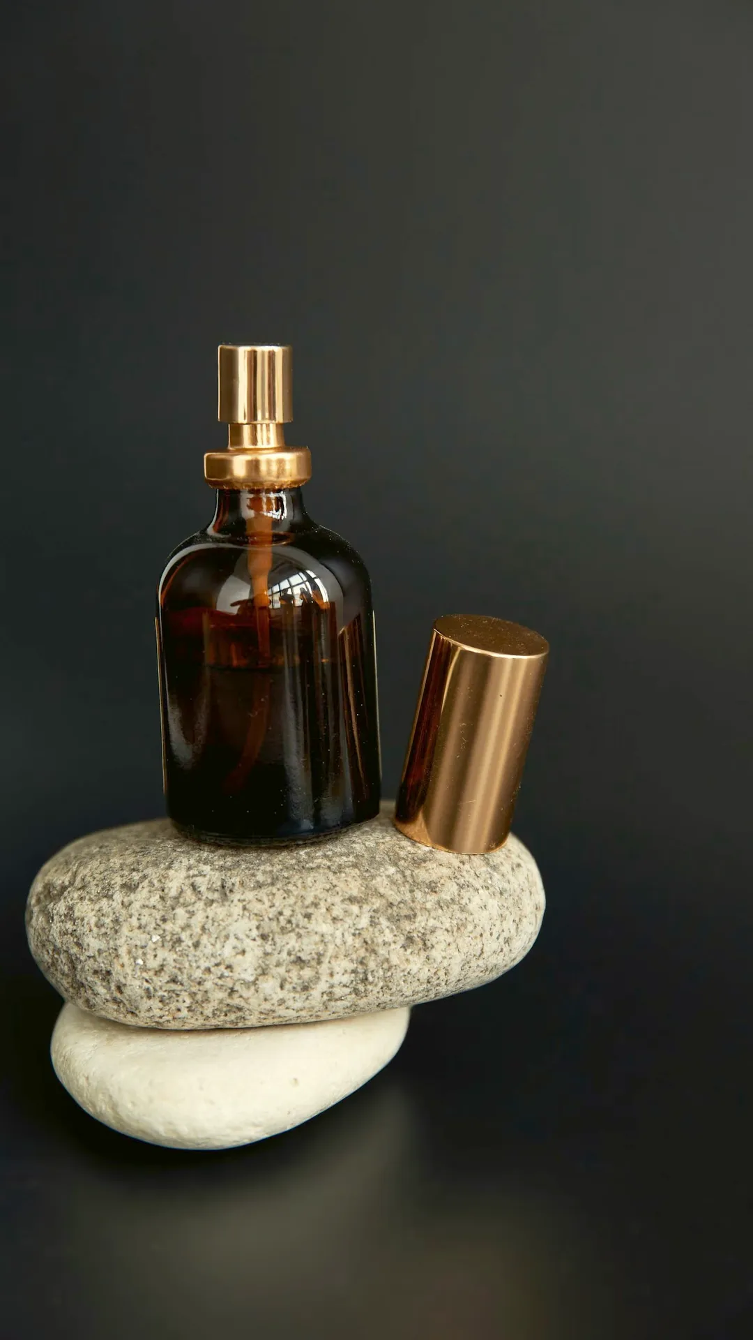 Single plain dropper bottle on stones
