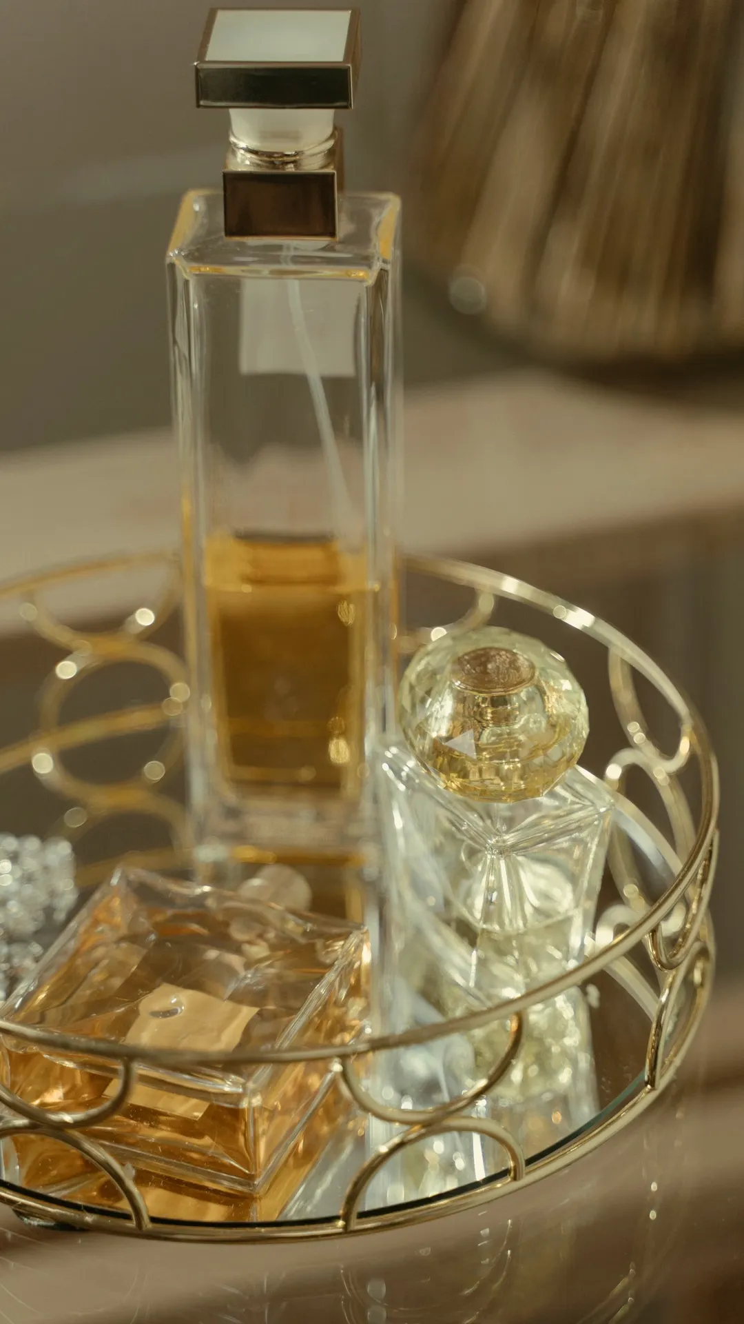Crystal perfume bottles on a brass vanity tray