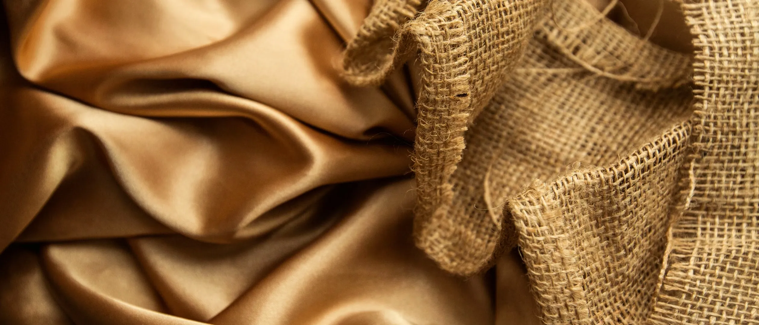 Champagne satin folds against burlap